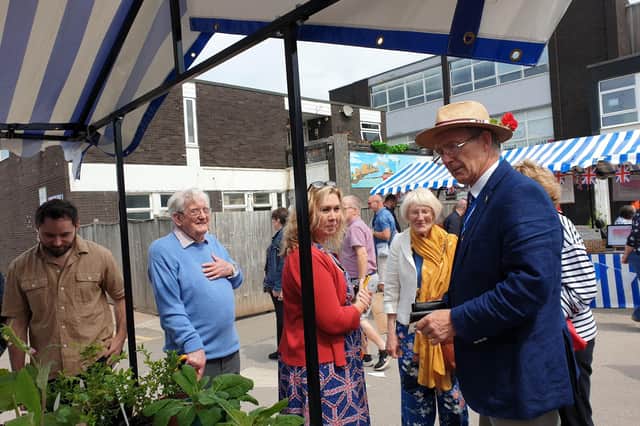 A photograph of the High Sheriff of Warwickshire, David Kelham, visiting Kenilworth in Bloom’s stall at Kenilworth’s Jubilee Market in Talisman Square. Picture submitted.