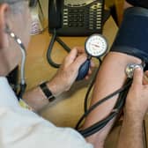 File photo dated 10/09/14 of a GP checking a patient's blood pressure. The majority of GPs are seeing patients over and above the "safe level" on a daily basis, a new survey suggests. Some 60% of family doctors say they see an average of 26-40 patients every day, according to a new survey by GP publication Pulse. Issue date: Monday August 21, 2023.
