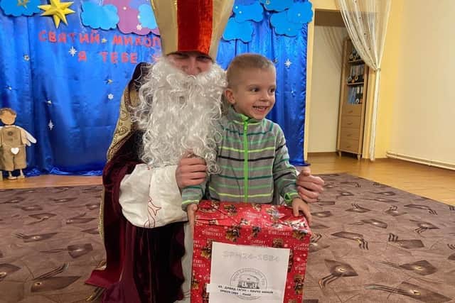 Davyd, one of the war orphans looked after by the monastery, with his Christmas present from Aid for Ukraine’s Secret Santa appeal. Picture supplied.