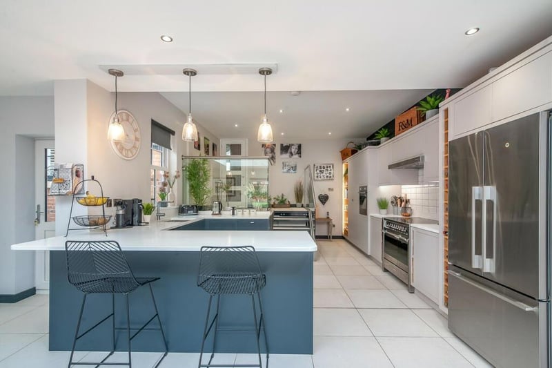 The kitchen section of the open plan kitchen/dining/living area. Photo by Fine and Country