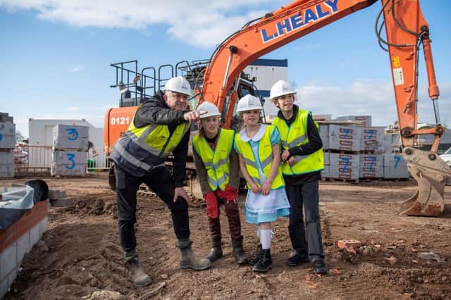 Bellway Site Manager Barry Aris and a group of pupils from Cubbington CofE Primary School on site at Bellway’s Hazelwood development in the village.