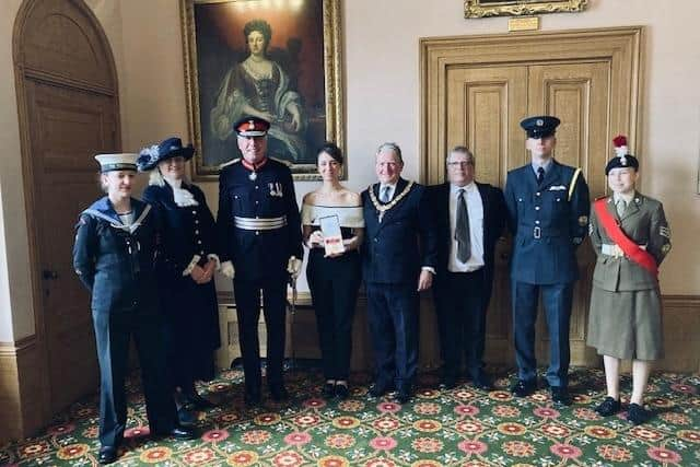 Elizabeth Baitson (fourth from left) being presented with her British Empire Medal by Lord Lieutenant Tim Cox, alongside local dignitaries including the High Sheriff of Warwickshire, Sophie Hilleary, Chairman of the County Council, Councillor Chris Kettle, and the Lord Lieutenant’s cadets.  Photo supplied