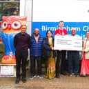The Rugby branch of the Shree Prajapati Association (SPA) hands over the money to the Birmingham Children's Hospital.