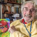 Cyril Hobbins in 2024 with his children's picture book Uncle Buckle: inventor extraordinaire. Picture supplied.
