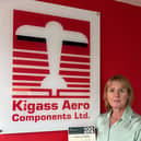 Joanne Wardman-Smith proudly displays Kigass' 100 year certificate from Companies House