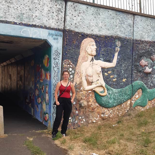Artist Katie O pictured at the mural ahead of work to refresh the colours of Helga Windle's design.