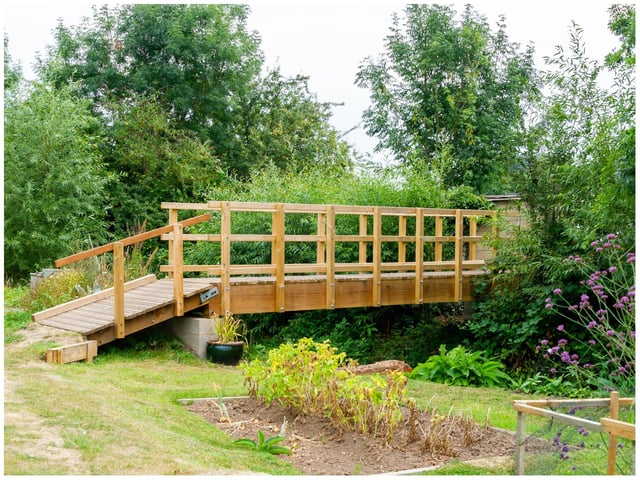 The newly constructed bridge, which straddles the Finham Brook, which will be ‘officially opened' during the open day event.
Local author, Peter James made a contribution towards the bridge through the sale of his book ‘Odibourne Sheds’, published recently.  Peter wanted to donate something to commemorate his father’s years spent on his allotment back in the 40s, and a small brass plaque on the bridge with his father’s name Alf James will be unveiled. Photo by Mike Baker