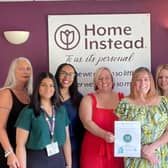 Staff at Home Instead Rugby celebrate their award.
