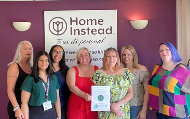 Staff at Home Instead Rugby celebrate their award.