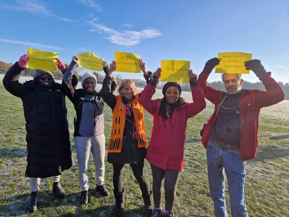 Diana Hancox (centre) with her supporters of her 2022 walking challenge. She is wearing the orange Alzheimer's Research UK top over her coat.