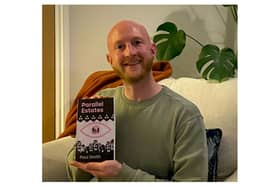Greg Smith with the book Parallel Estates. Photo supplied