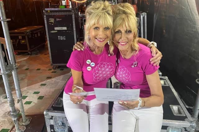 Barbara Graham (left) and her sister Janette Fairclough (right) learn their lines to announce Coldplay at the band's recent Wembley concert. Picture supplied.