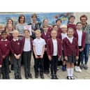All Saints’ Church of England Junior School pupils, foundation governors, and Mrs Garrett, global citizens leader and Sandra Sutherland, headteacher). Photo supplied