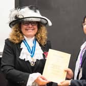 Karen Lynch MBE presenting Sarayu Kotha with her project completion certificate.