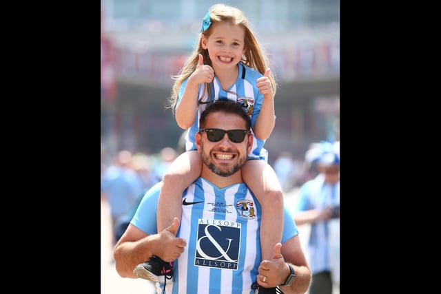 Fans pose for a photo as they arrive outside the stadium prior to the Sky Bet League Two Play Off Final between Coventry City and Exeter City at Wembley Stadium on May 28, 2018.