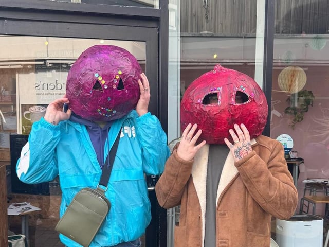 Residents wearing some of the pumpkin heads,