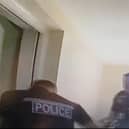 A still image taken from the bodycam footage from the raid carried out by police officers from Warwick and Leamington Safer Neighbourhoods Teams this morning. Credit: Leamington Police.