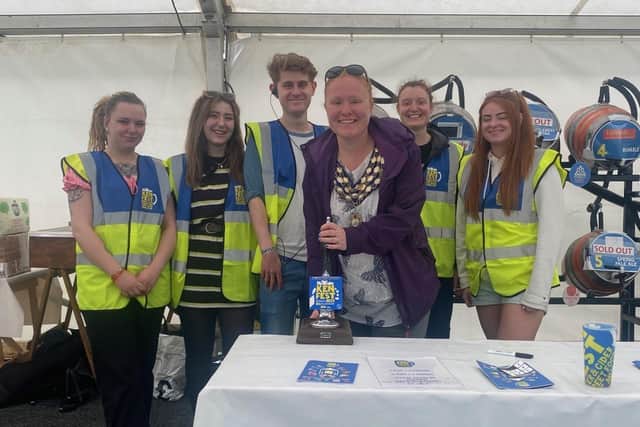 Kenilworth Mayor, Samantha Louden-Cooke with KENFEST volunteers, pulling a pint of KENFEST Ale brewed specially for the event by Warwick based Slaughterhouse Brewery. Photo supplied