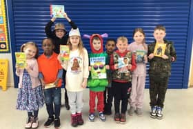 Lighthorne Heath Primary School pupils celebrate receiving a donation of books for their school library from Taylor Wimpey on World Book Day. Picture supplied.