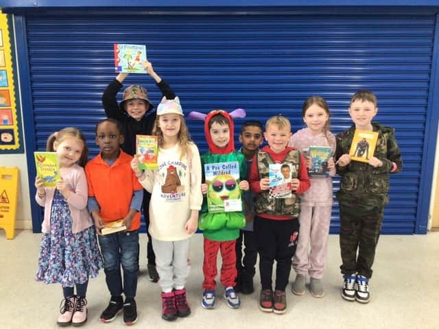 Lighthorne Heath Primary School pupils celebrate receiving a donation of books for their school library from Taylor Wimpey on World Book Day. Picture supplied.