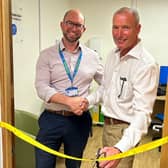 Mark Harrington (right) cuts the ribbon with his colorectal surgeon, Mr Henry Ferguson (left). Picture supplied.