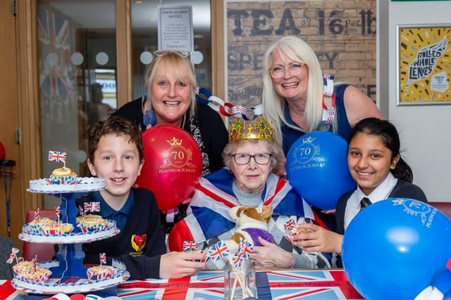 Generations old and young united in celebration of the Queen’s Platinum Jubilee at the appropriately named Queensway Court – an extra care scheme in Leamington.
Older residents at the Orbit managed scheme were joined by 30 children from St Patrick’s Catholic Primary School to participate in royal-themed activities including decorating cupcakes, making paper crowns and singing the national anthem.
Pictured here are (top row) Deborah Harris, (activities coordinator for Orbit) and Janet Barnett (high level teaching assistant at St Patrick’s Catholic Primary School) with (bottom row) Oskar Krupiczowicz, (head boy St Patrick’s Catholic Primary School), Jean Dooley, resident at Queensway Court and Maya Hundal (head girl St Patrick’s Catholic Primary School).