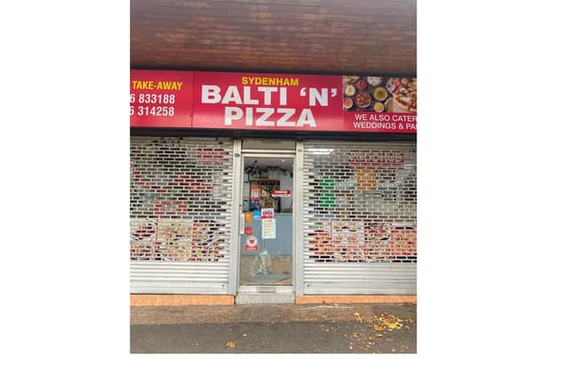 The smashed window on the front door of Sydenham Balti 'N' Pizza. Picture supplied.