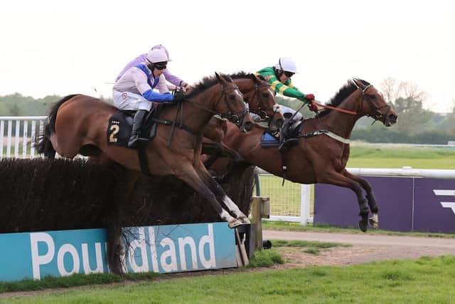 Boombawn (left) jumps the last fence alongside Way Out (centre) and Call Of The Wild