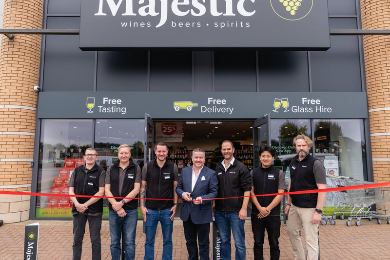 John Colley, Majestic CEO, cuts the ribbon with the Majestic team.