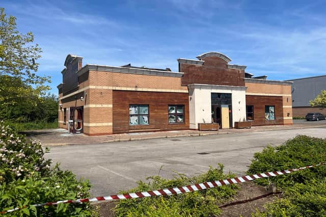 The unit as it appeared the morning after the fire - with portions of the roof collapsed.