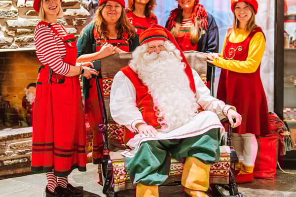 Santa Claus and his helpers ready to receive letters from around the world