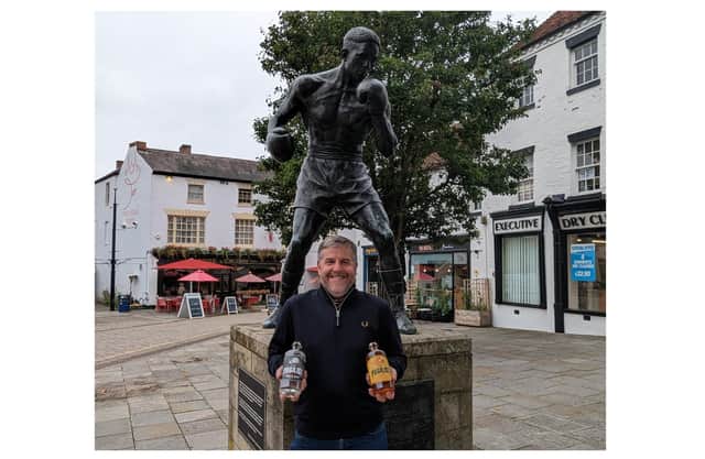 Dave Blick, of Warwickshire Gin Company, at the statue of Randolph Turpin in Warwick, with the new rums.