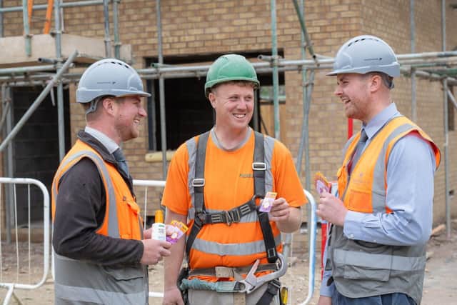 Matt and George giving the cards out to members of their site team