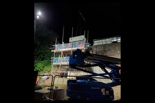 Staff waiting for the lift shaft to be moved into place.