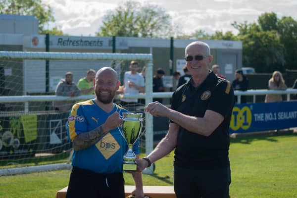 Jim Scott, chairman at Leamington FC, hands over the trophy