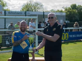 Jim Scott, chairman at Leamington FC, hands over the trophy