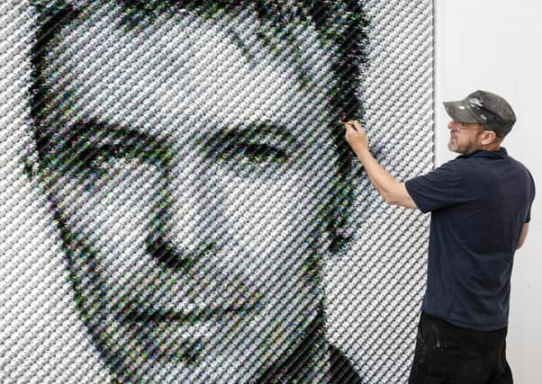 Artist Joe Black adds the finishing touches to a portrait of David Bowie made from over 8,500 guitar plectrums, commissioned by Sky Arts to celebrate Bowie topping a new definitive list of Britain's 50 most influential artists of the past 50 years