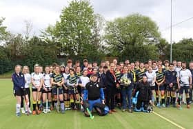 Sarah Butterfield and Julia Bower (centre) surrounded by members of Rugby and East Warwickshire Hockey Club at Rugby College.