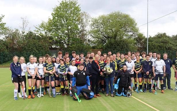 Sarah Butterfield and Julia Bower (centre) surrounded by members of Rugby and East Warwickshire Hockey Club at Rugby College.