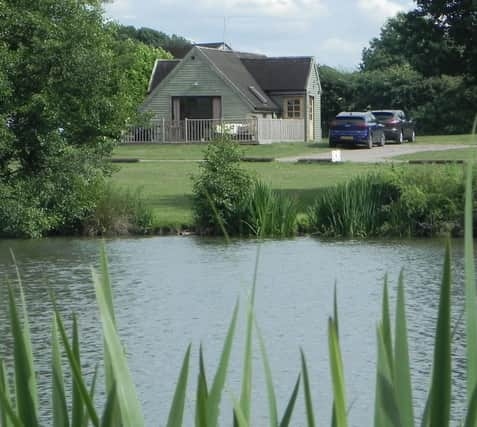 The Skylark Lodge at Brook Meadow viewed from across the campsite's five-acre fishing lake