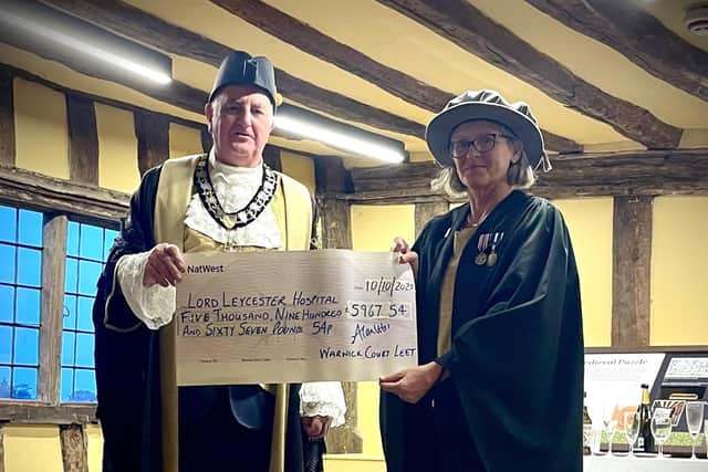 Alan Letiss, past Bailiff of Warwick Court Leet, presents Heidi Meyer, Master of The Lord Leycester, with a cheque for almost £6,000. Photo supplied