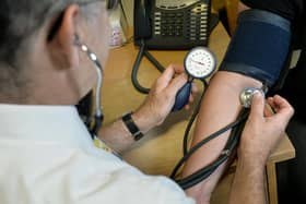 File photo dated 10/09/14 of a GP checking a patient's blood pressure. A scheme introduced to enhance access to general practice by bringing in staff such as pharmacists and physician associates could be driving down GP vacancies, a new survey suggests. Issue date: Monday November 27, 2023.