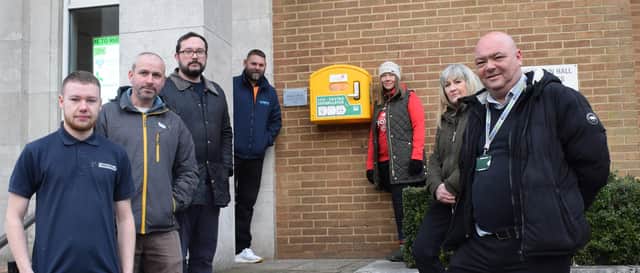 Croxford Electrical's Ollie Fricker, Cllr Simon Ward, Cllr Seb Lowe, Jeremy Issitt, Naomi Rees-Issitt, Rugby Borough Council corporate property officer Elaine Allso and Darren Reeves, the council's housing maintenance officer (electrical), with the defibrillator at the Town Hall.