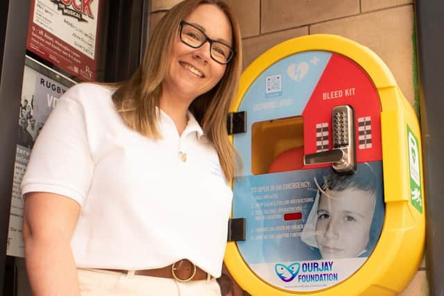 Naomi next to the latest piece of life-saving equipment featuring her son Jamie's face.