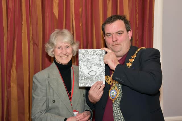 Leamington History Group Secretary, Margaret Rushton presents a copy of Global Leamington to Leamington Mayor, Nick Wilkins. Photo by Allan Jennings.