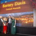 Barney Davis, the franchise owner of Caremark Warwick receiving his award