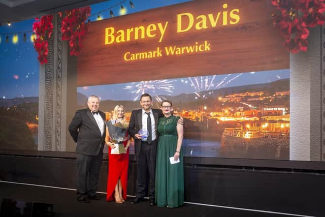 Barney Davis, the franchise owner of Caremark Warwick receiving his award