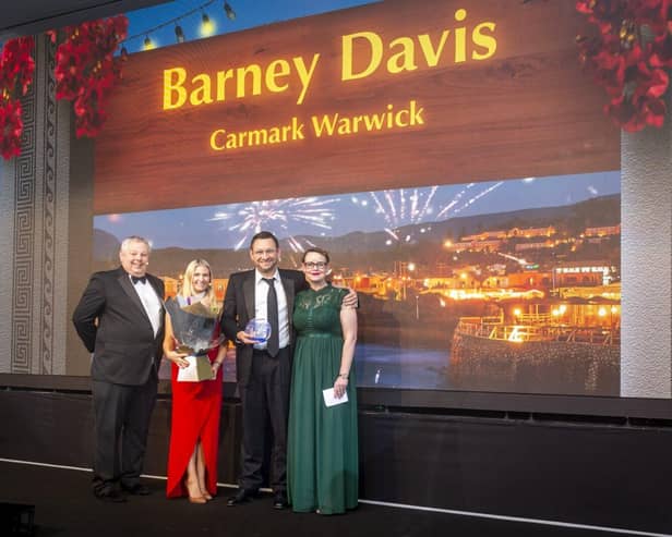Barney Davis, the franchise owner of Caremark Warwick receiving his award