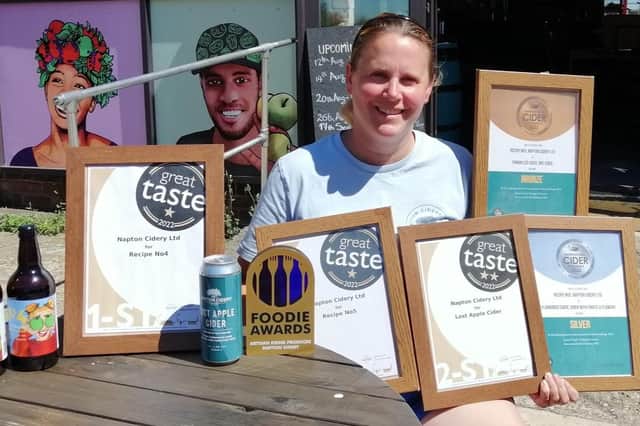 Charlotte Olivier of Napton Cidery with the awards haul and some of the cidery's award-winning products.