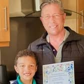 Steve with son Oliver and his invitation to the coronation.